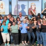 Staff posing in front old bookmobile