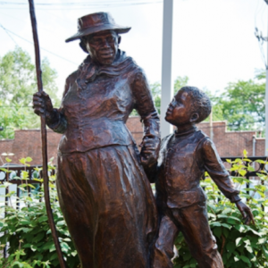 bronze statue of Harriet Tubman guiding a child