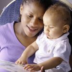 African american mother reading with her baby