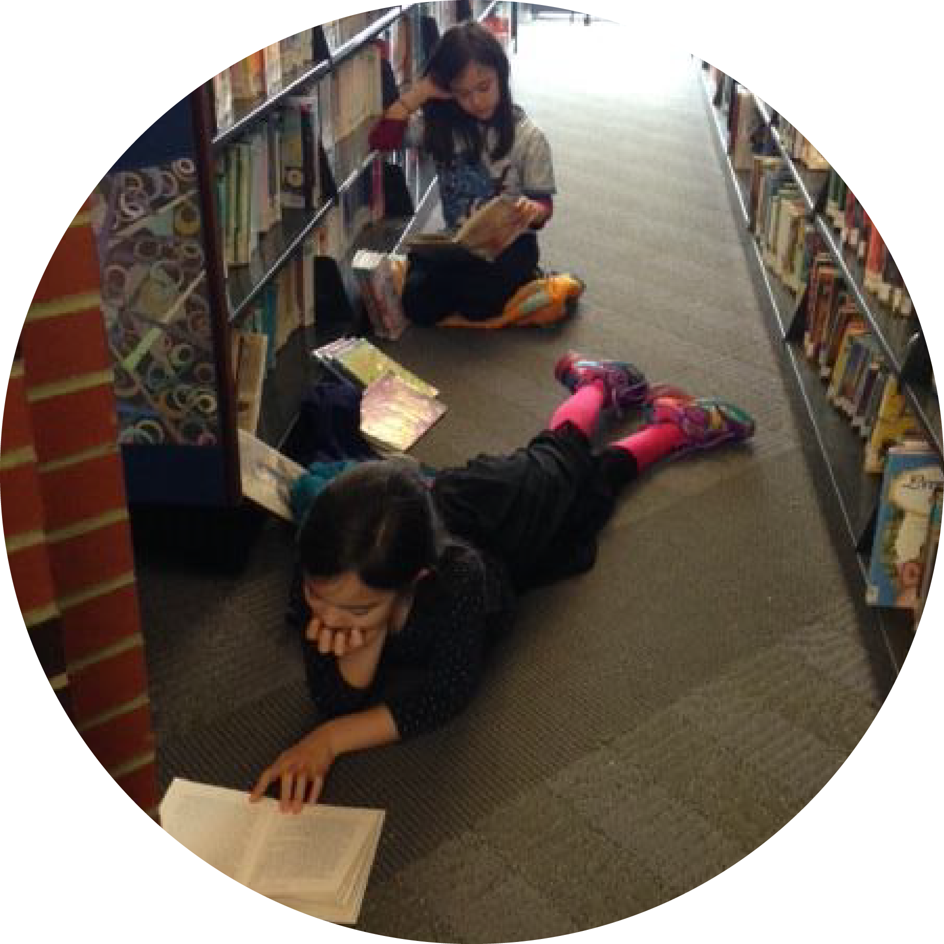 Two children reading in the stacks at the downtown library