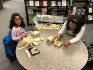 two girl building with blocks