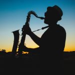 Silhouette of person playing the saxophone