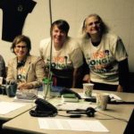 Library volunteers smile at camera