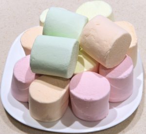 large multiple colored marshmallows stacked on a plate