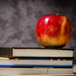 apple on top of stack of books