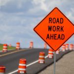 Road construction zone with orange warning sign