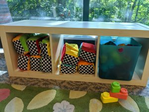 toys in a wooden shelving unit