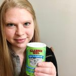 youth librarian Liz holds a jar of baking soda while smiling