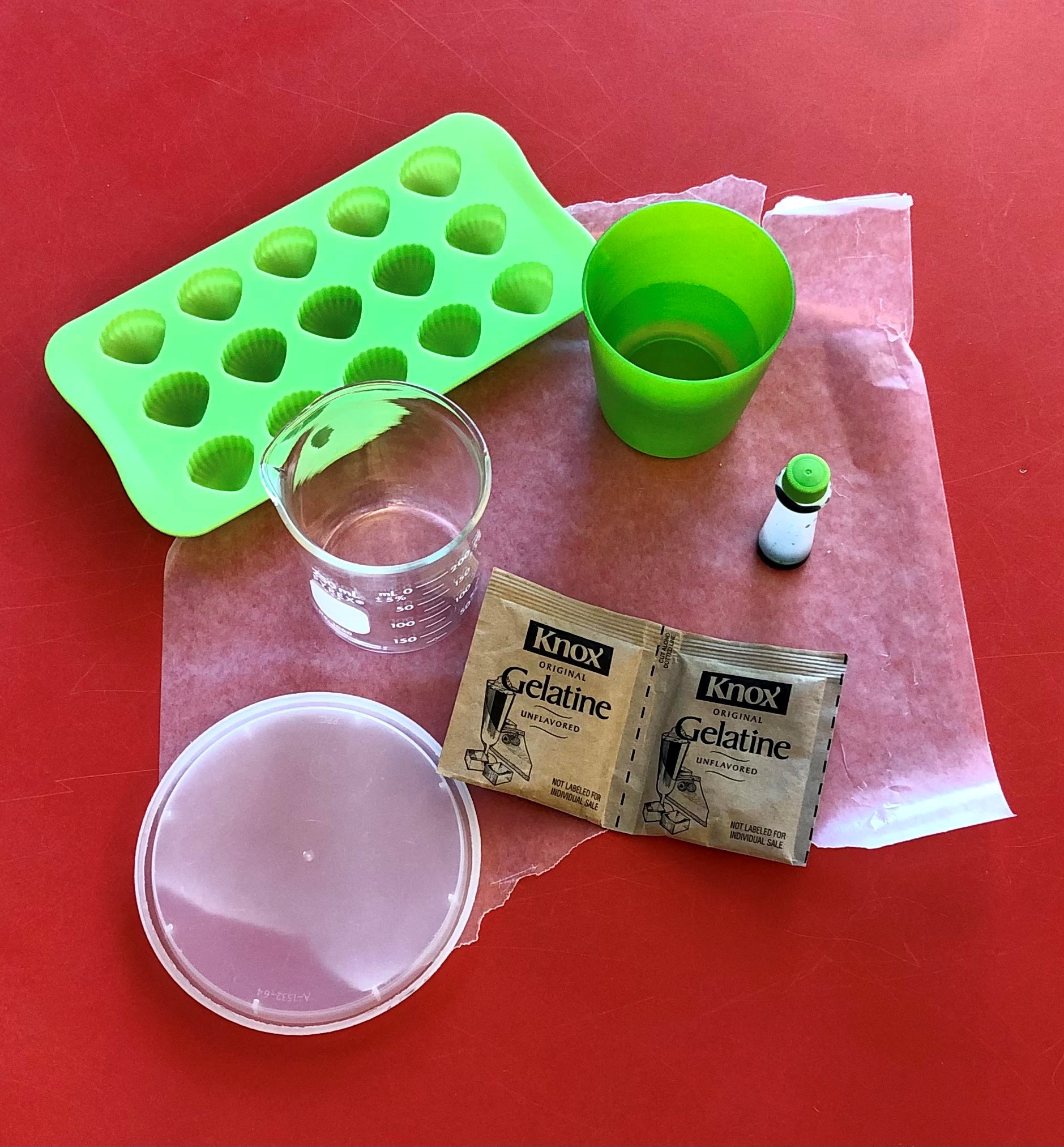 Gelatin Plastic all the ingredients for making gelatin plastic are displayed on a red table