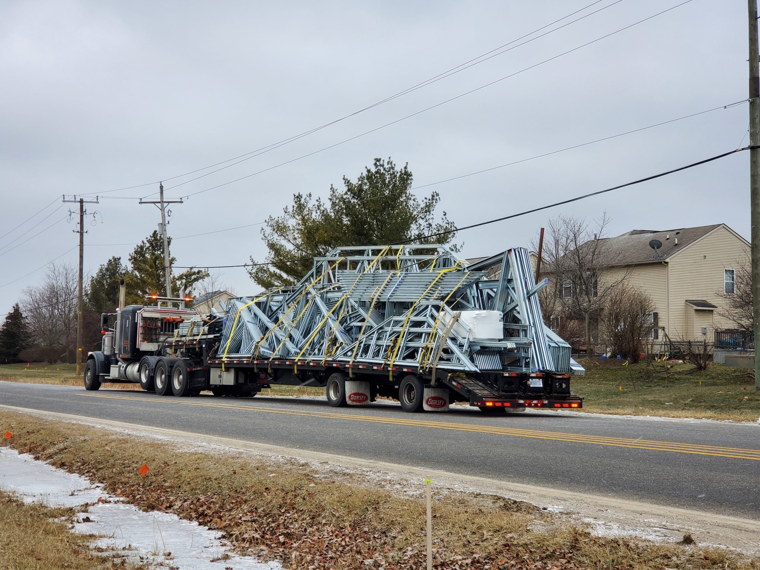 Trailer delivering roof trusses to new Superior library