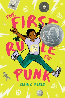 The First Rule of Punk. A girl is jumping in the air with her legs kicked out and her hands raised in the air.