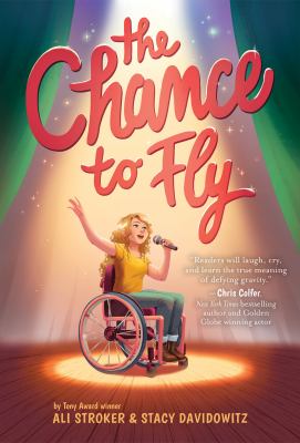 9781419743931 The Chance to Fly by Ali Stroker and Stacy Davidowitz. A girl in a wheelchair sings on a stage.
