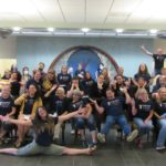 All of the library staff (about 50-60) making various silly poses in front of the front desk at YDL-Whittaker.