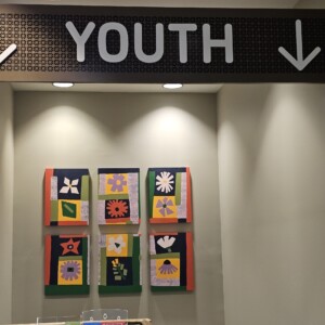 Mural artwork on the wall underneath a sign that says Youth.